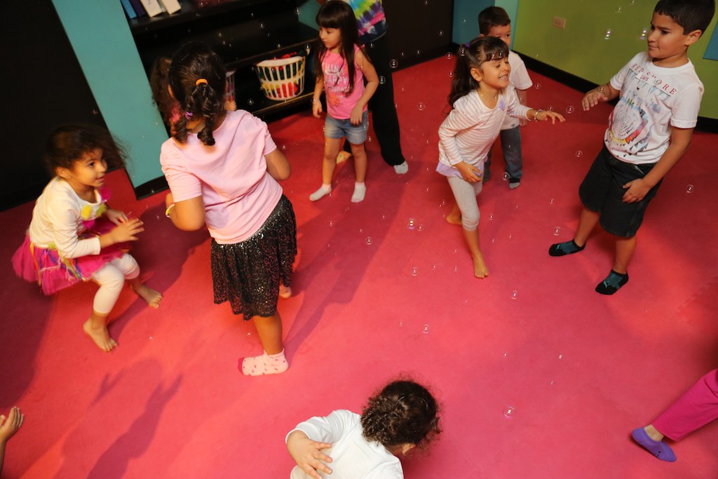 many children are standing and playing in the floor