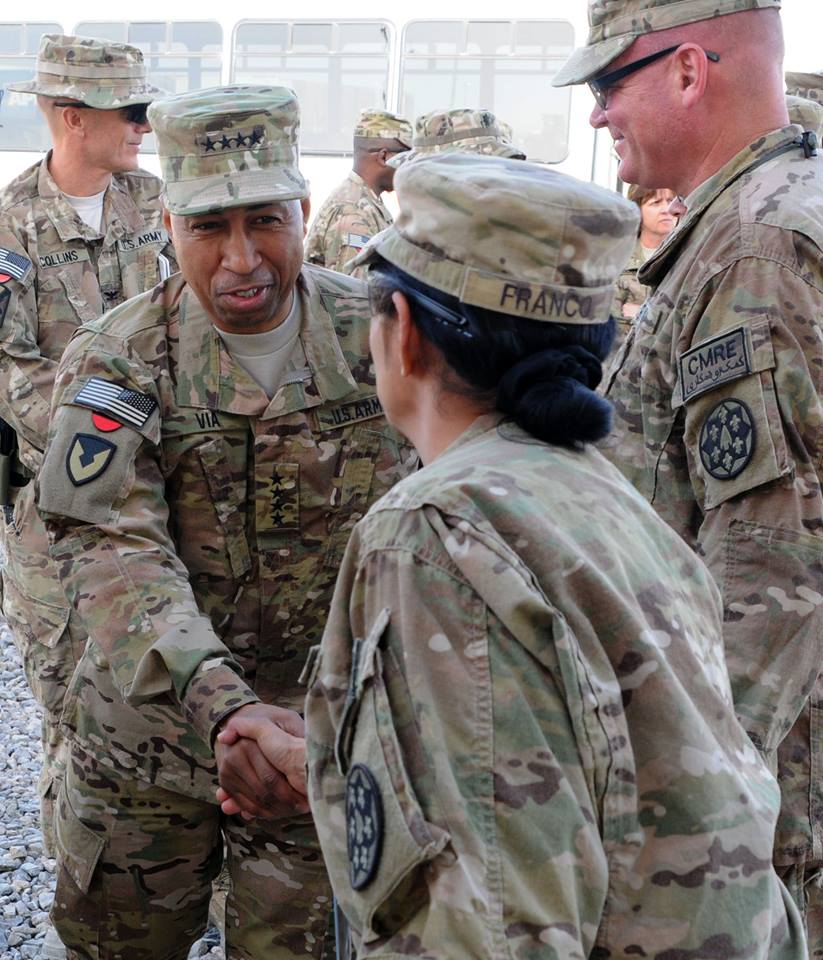 military personnel in uniform greeting each other and talking