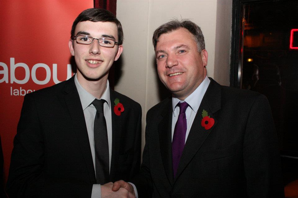 two men shake hands at an event