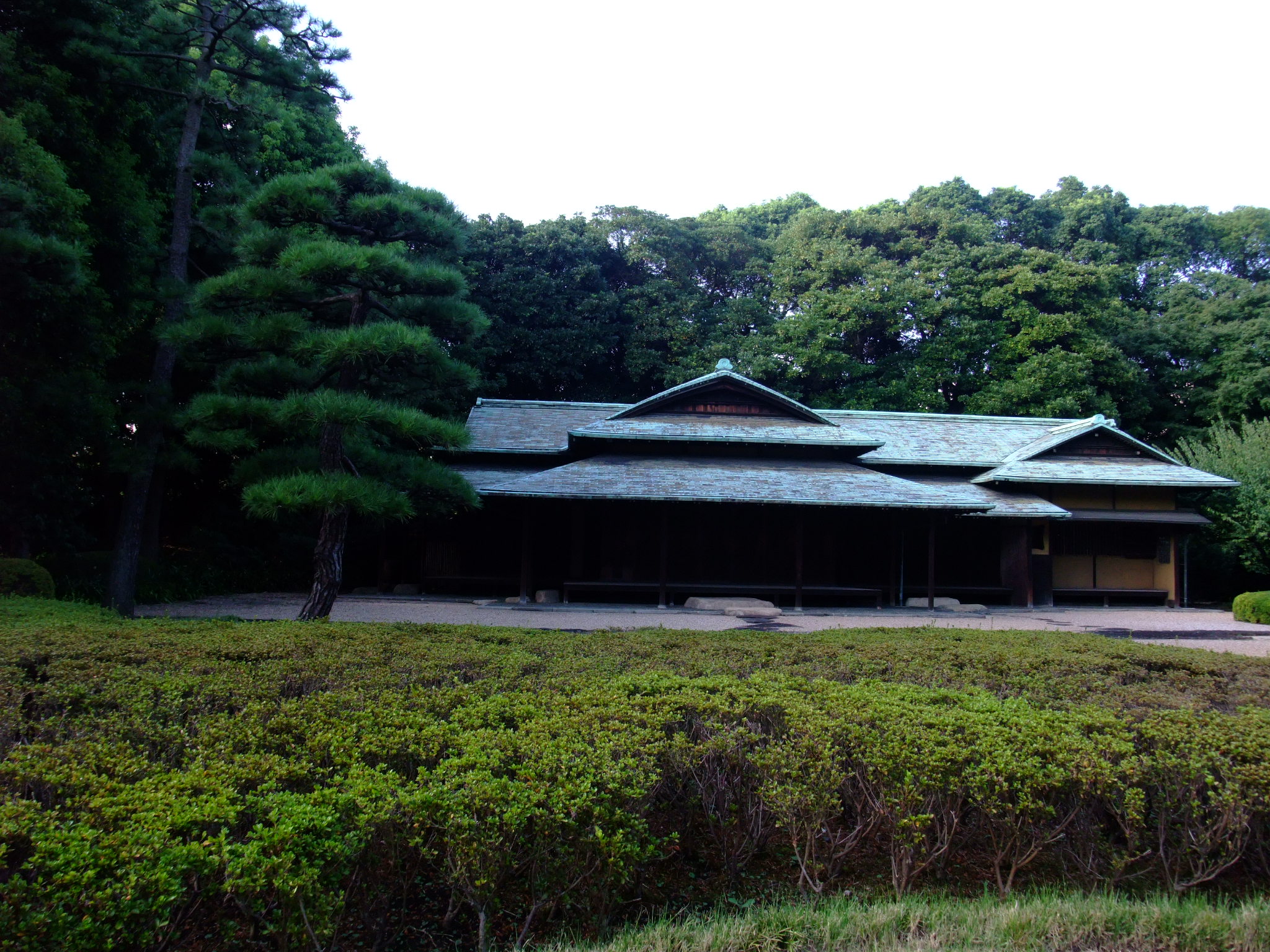 a large building in a field with trees around it