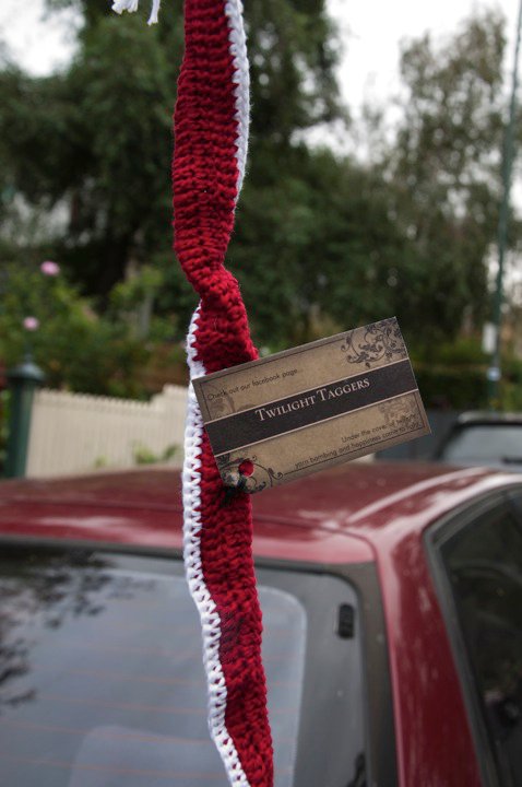 a red and white decoration with a brown sign on it