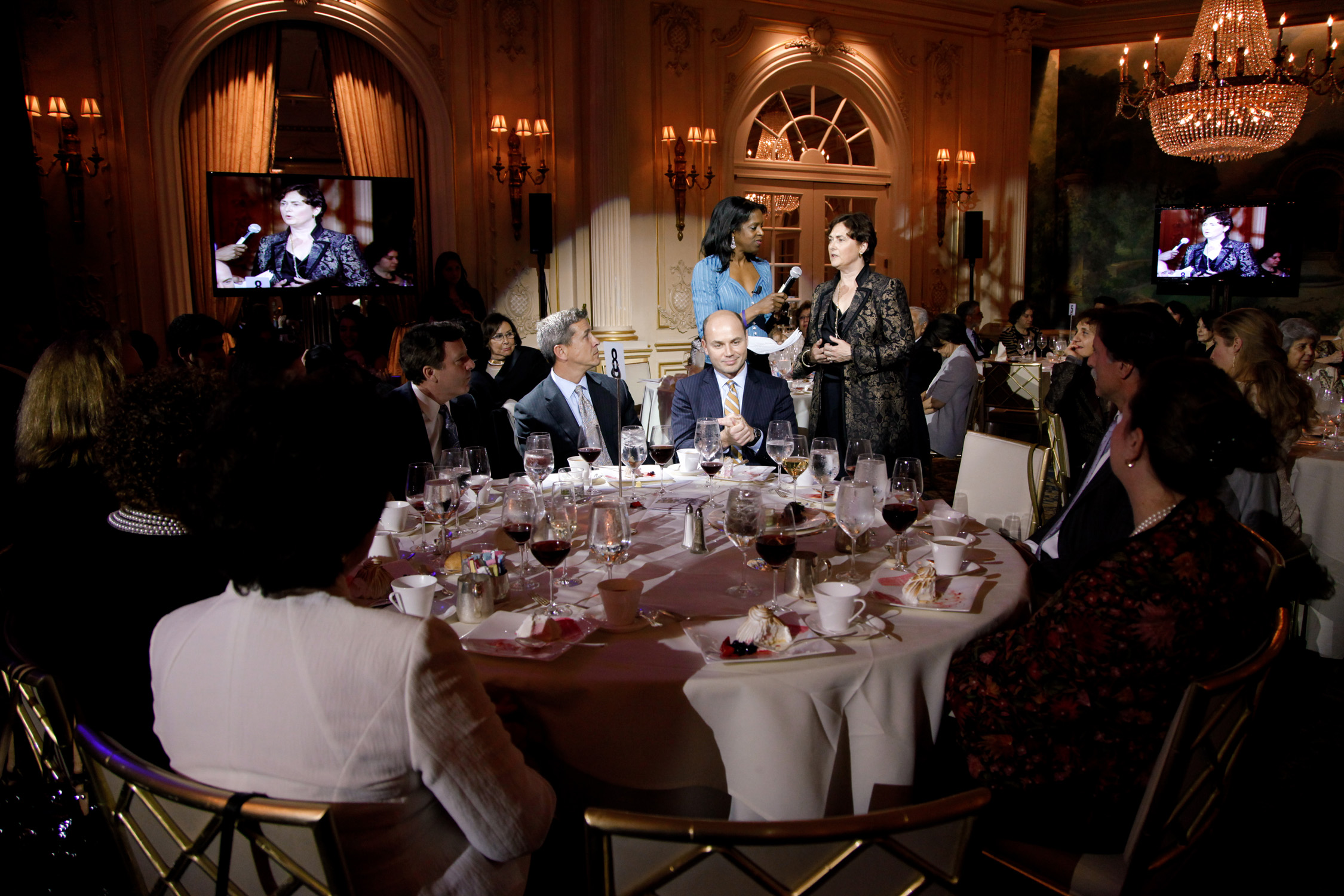 a group of people sitting around a round table