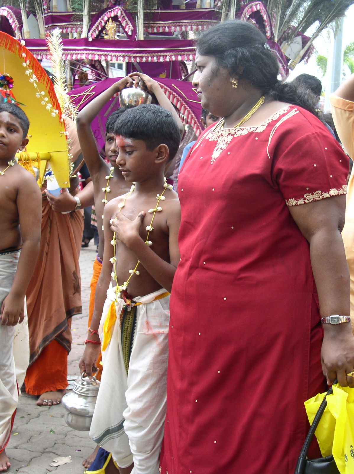 the men are wearing orange saris in the street