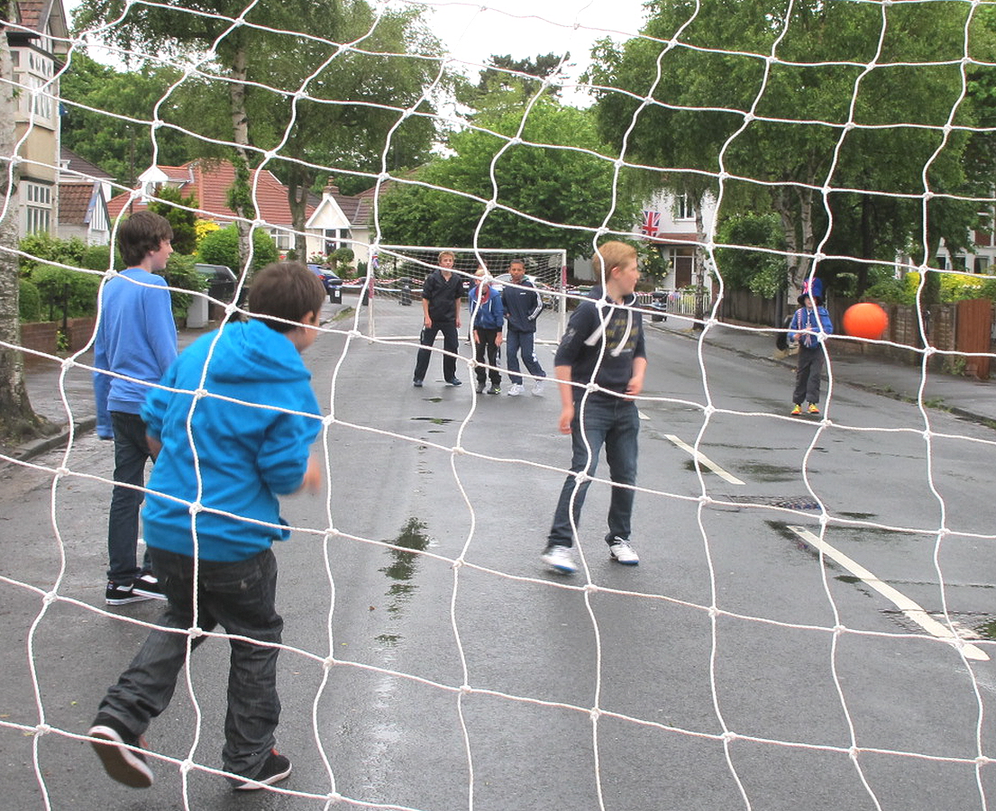 s play soccer on the street during the day