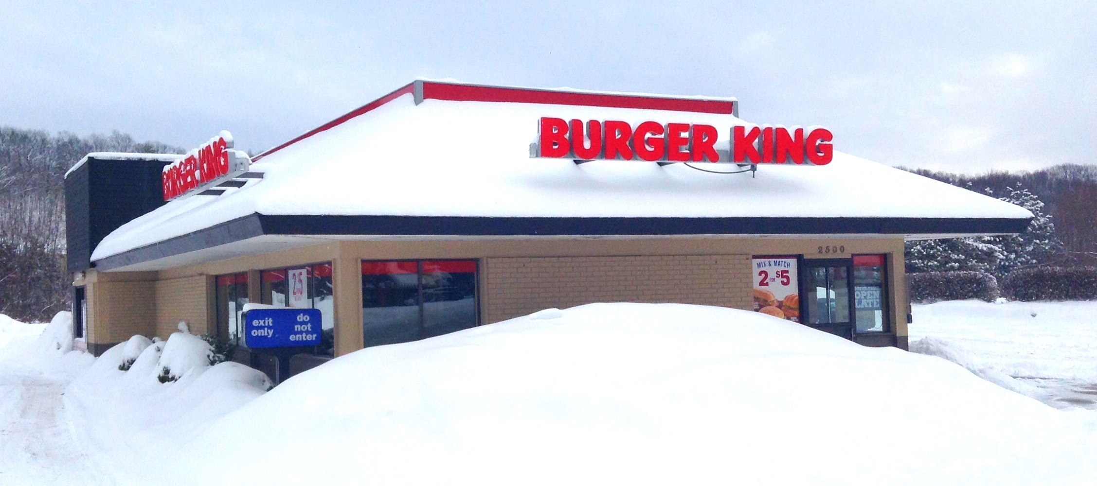 the outside of a frozen burger king restaurant in the snow