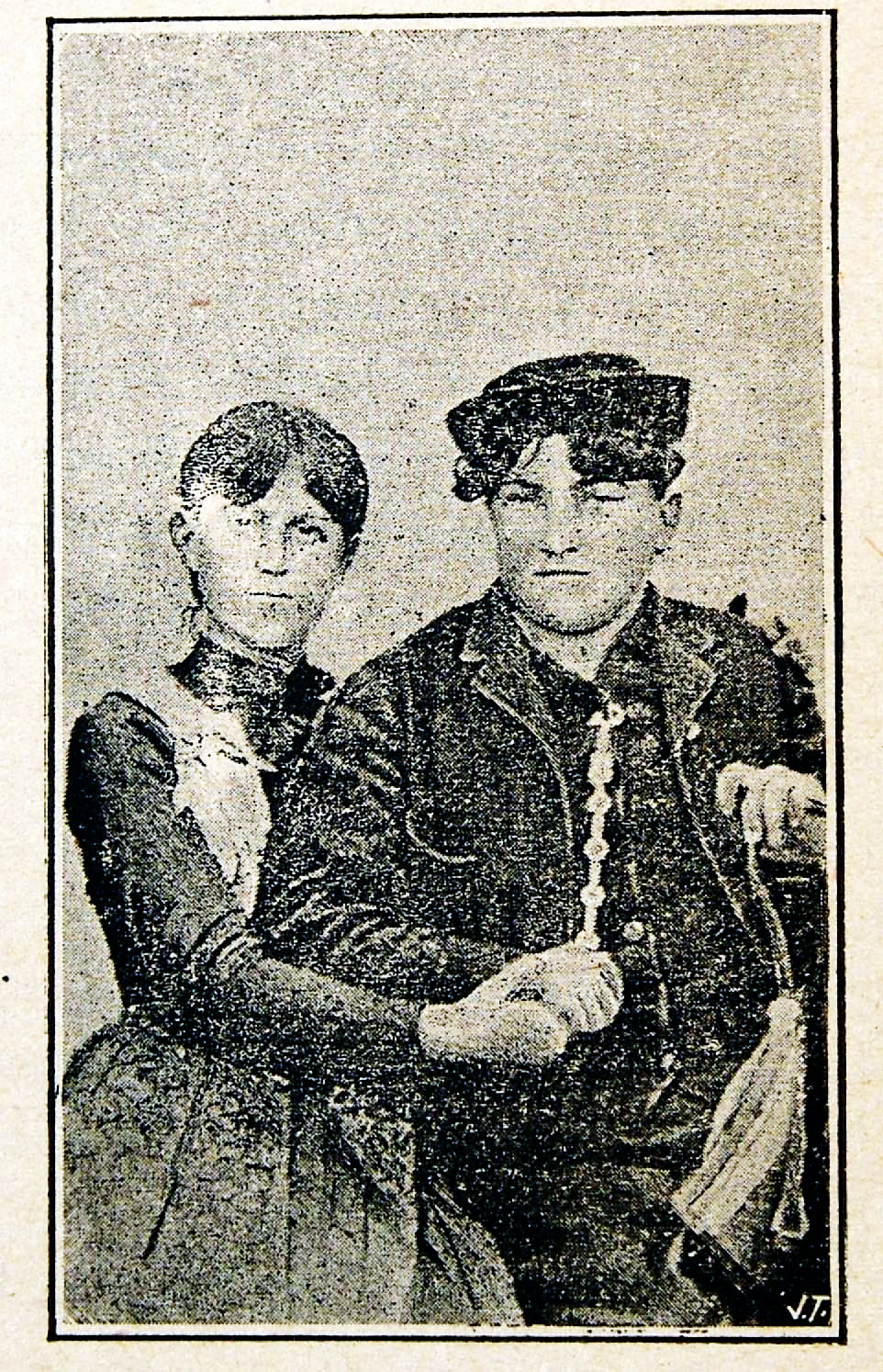 an old newspaper clipping shows two people sitting in a chair