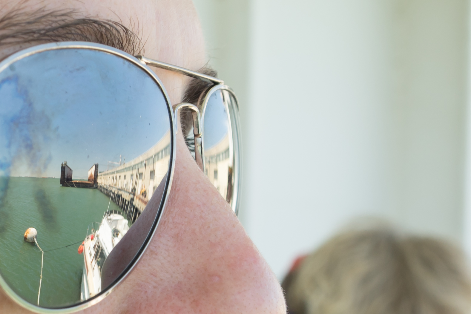 a person wearing reflective glasses is reflected on his eye