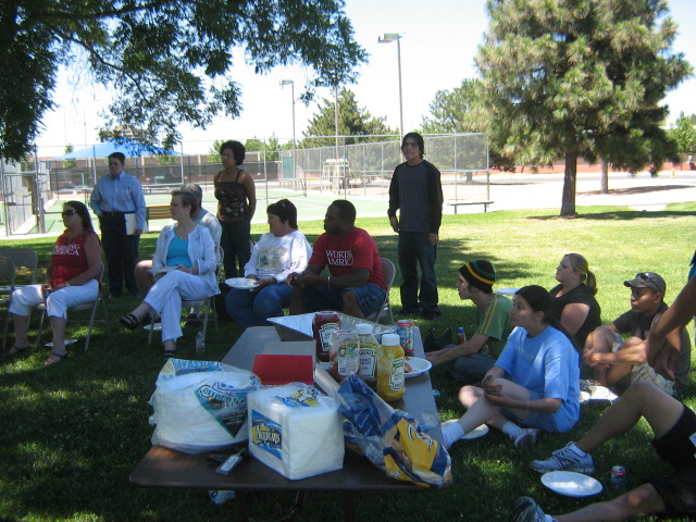 a group of people sitting on the grass