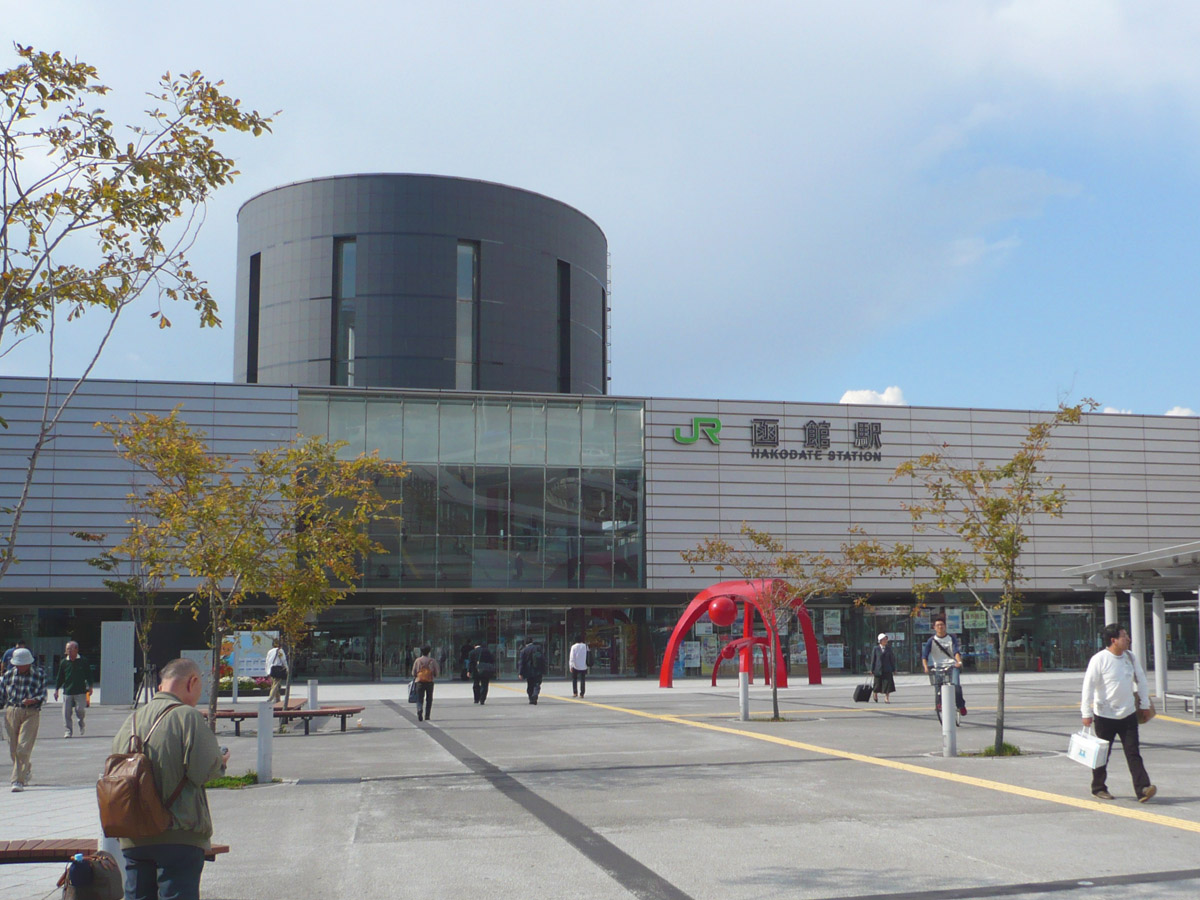 a crowd of people that are standing near the entrance