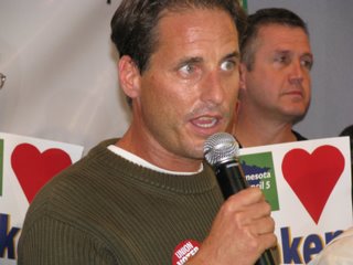 a man holding a microphone in front of two people