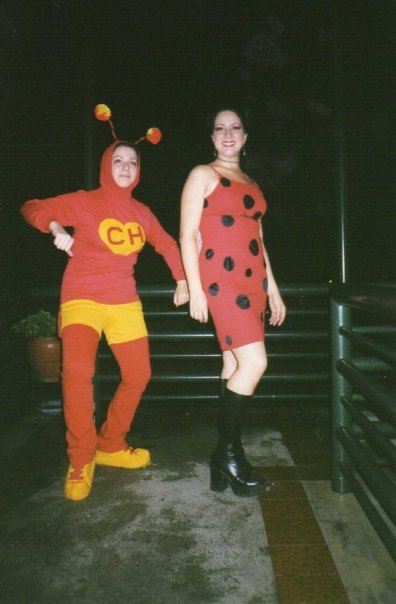 two people dressed as bugs on a walkway