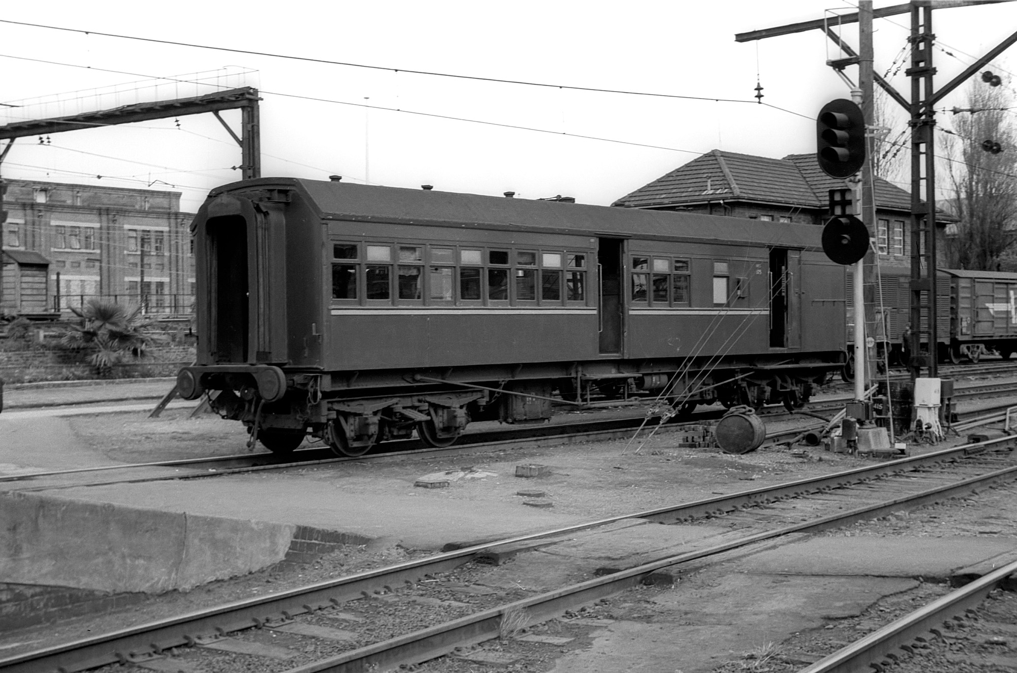 an old style train with an attached car