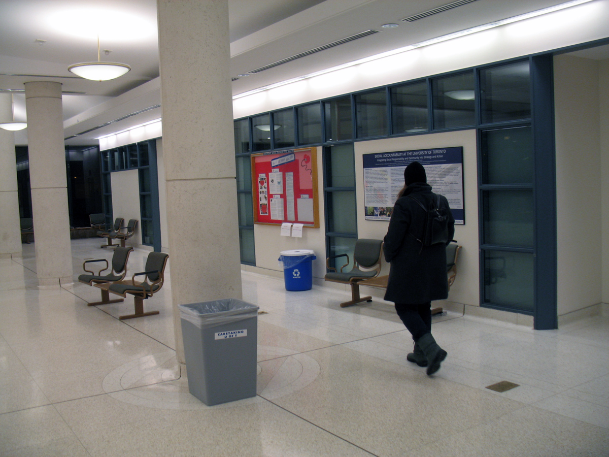 a woman in winter clothes walking down an airport