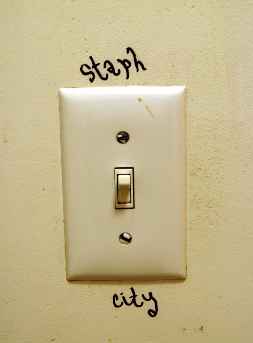 some writing on a wall near a light switch