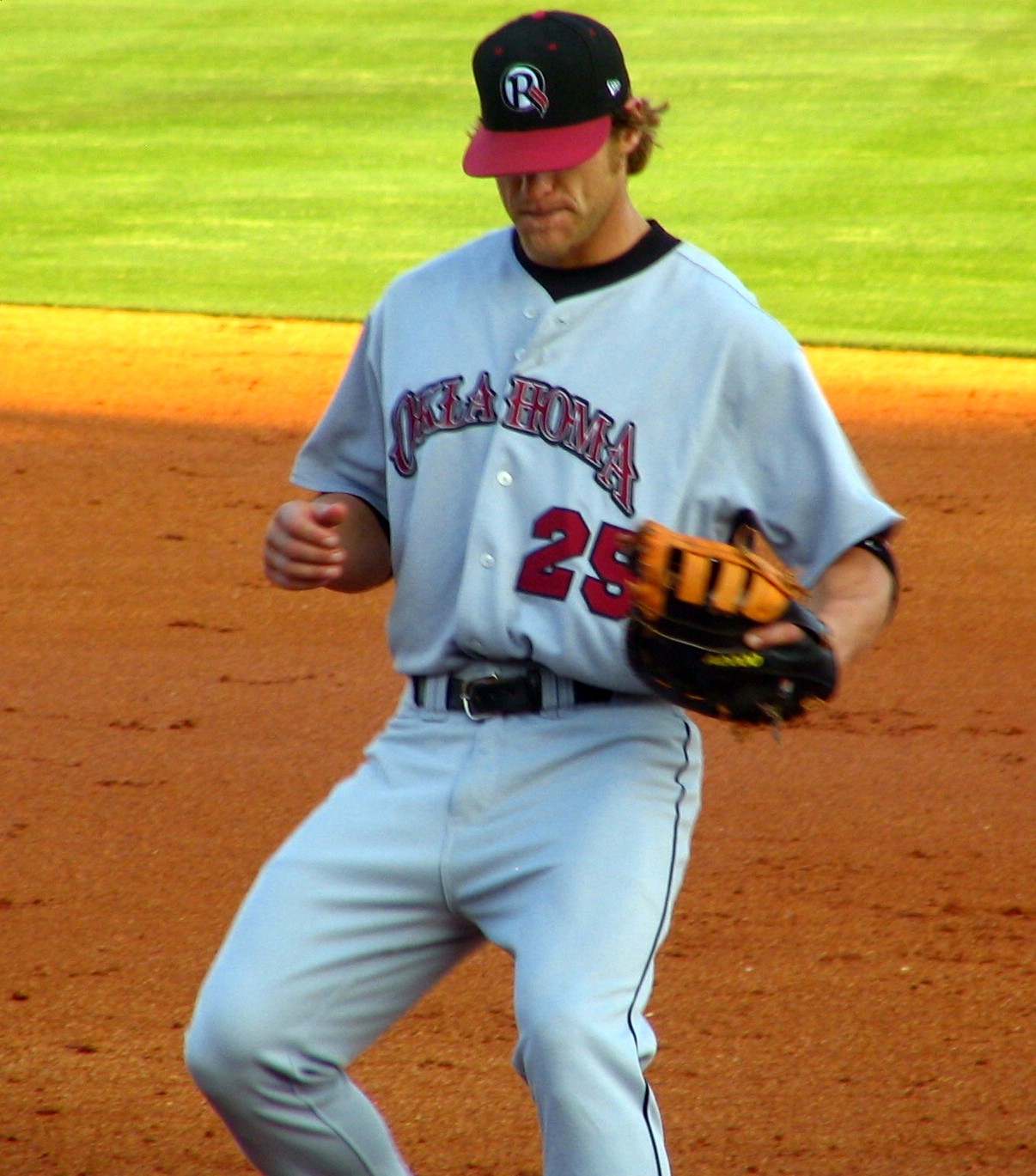 a baseball player standing on the field in the middle of a play