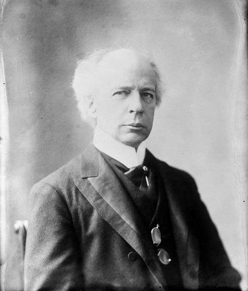 black and white pograph of a man in suit