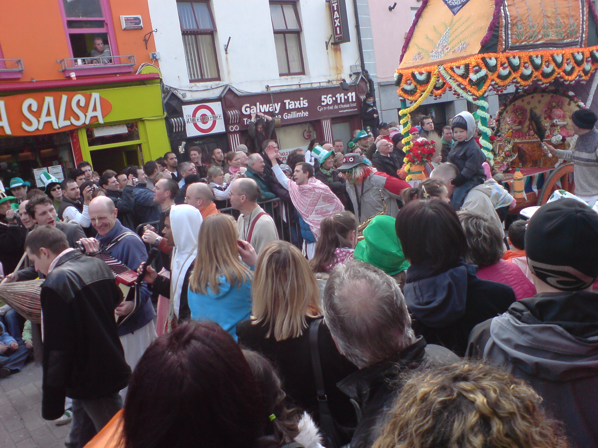 a man and woman standing next to a crowd