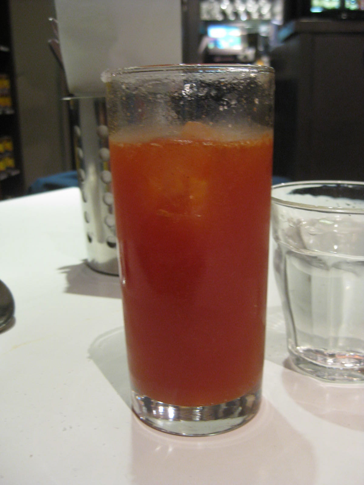 a cup with a drink on the counter next to glasses of water