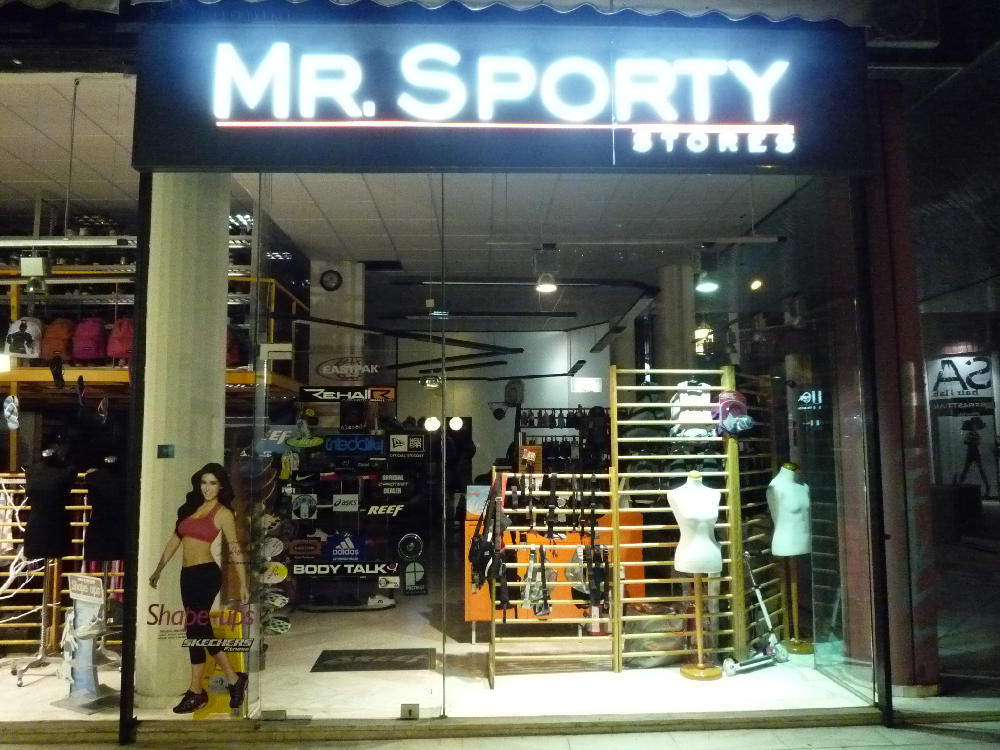 woman standing in front of sports clothing shop