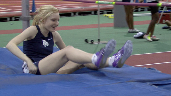 a woman wearing purple shoes on a track