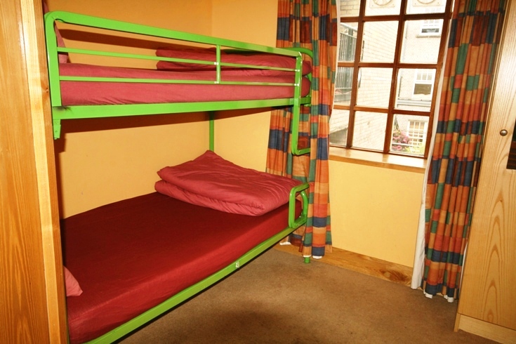 a bunk bed that has a single mattress on top