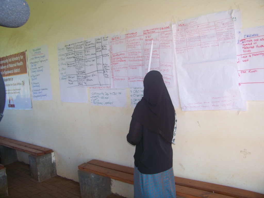 a person writes on the wall with her head in her hands