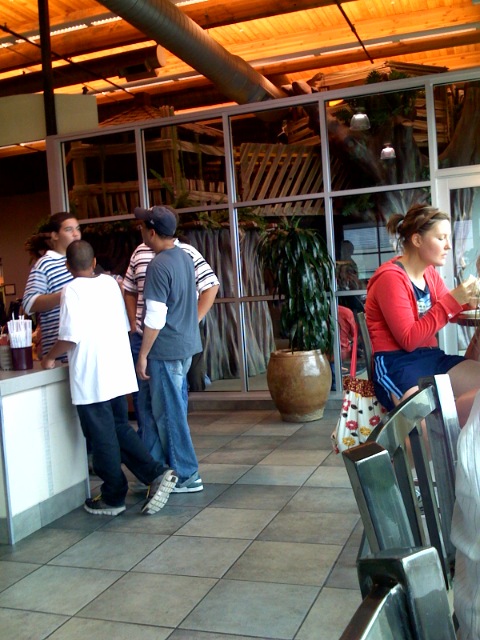 a woman carrying a tray of food next to a restaurant