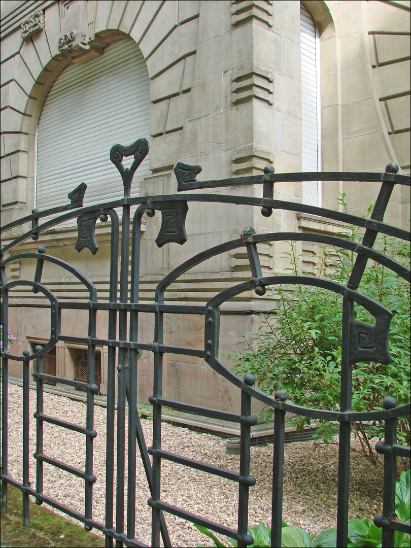 a decorative iron fence sits next to the entrance