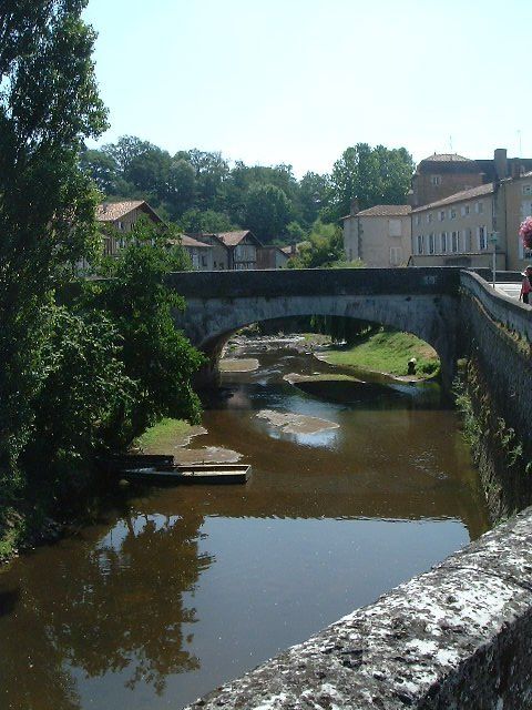 a bridge over a river next to buildings