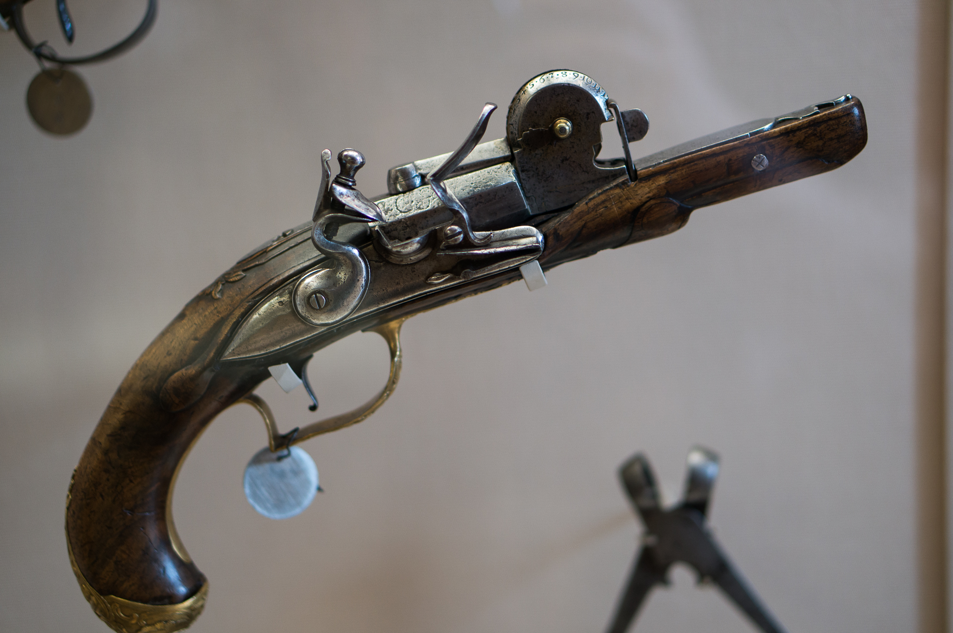 an antique colt rifle mounted to a wall
