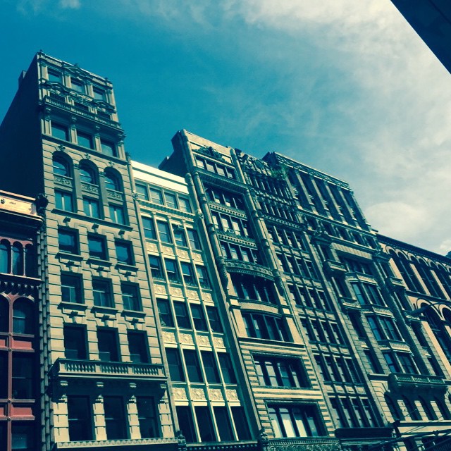 several buildings are lined up on the side of a street