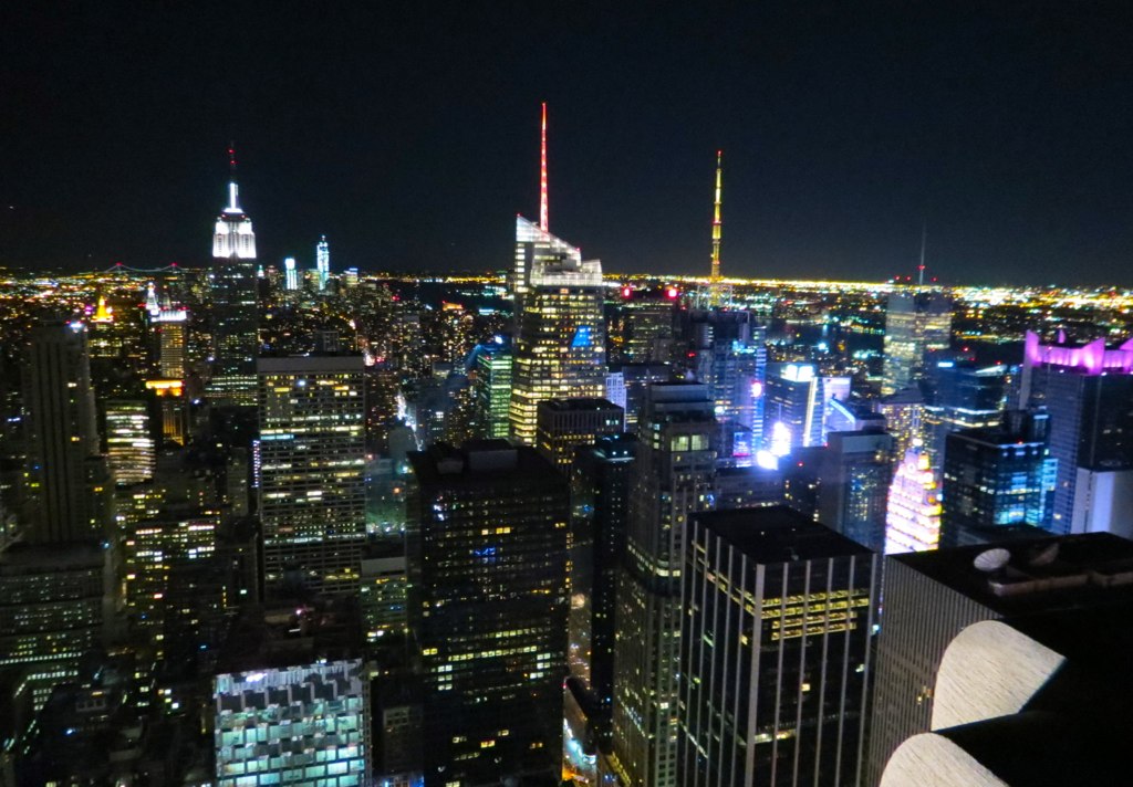 the city lights and skyscrs at night from a high altitude viewpoint