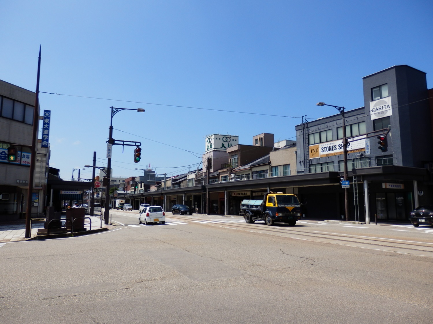 an empty city street near buildings and traffic lights