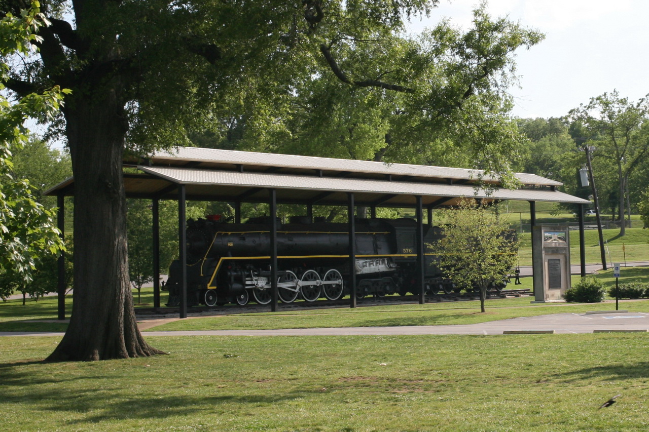 a train is parked in front of a shelter