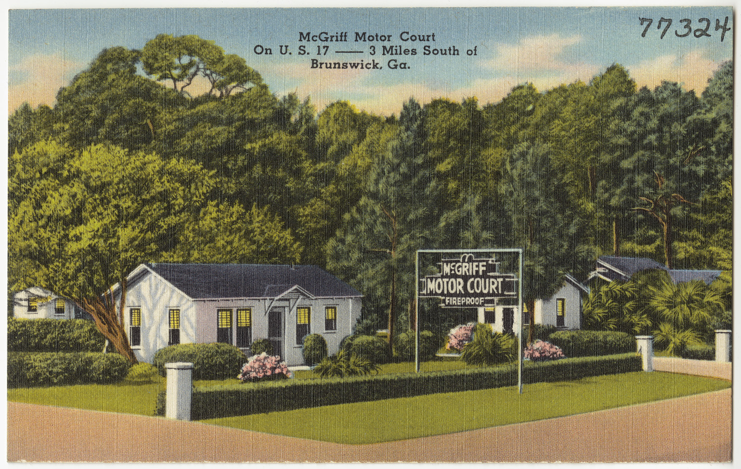 this is a small postcard of motels in a wooded setting
