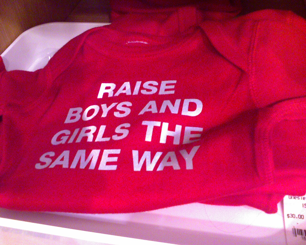 a pair of red t - shirts saying raise boys and girls the same way