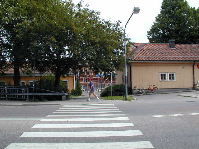a crosswalk at an intersection with a pedestrian crossing