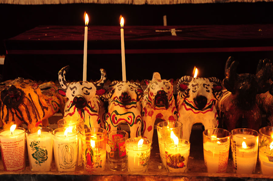 candles and masks in front of a large table