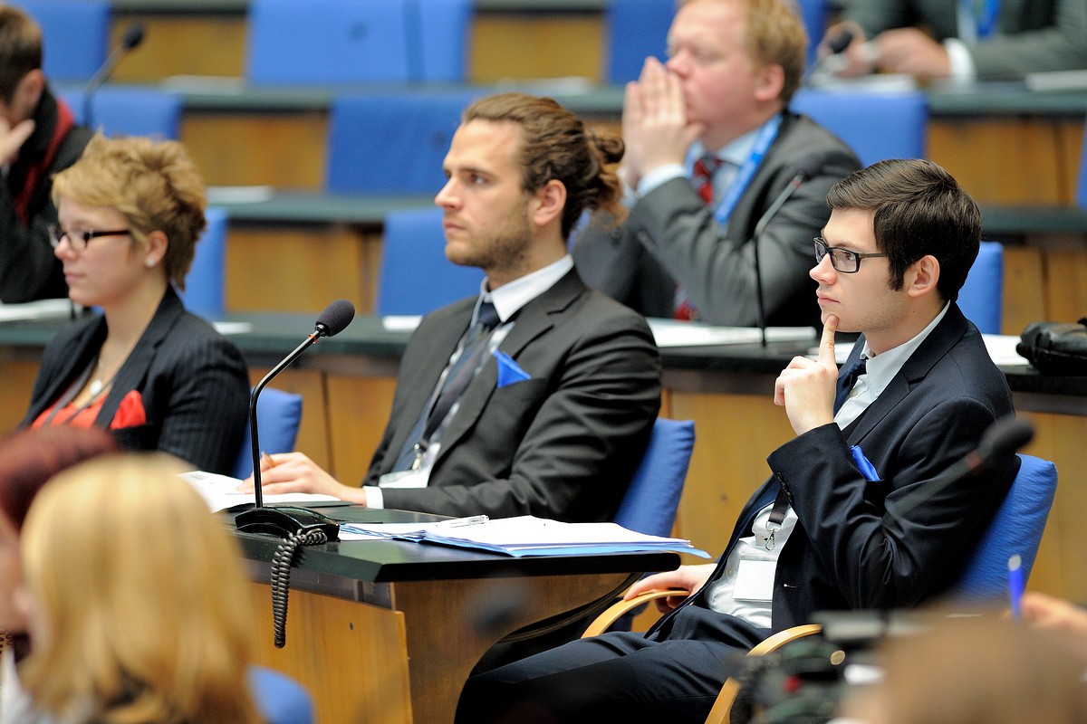 people in a conference hall looking up during a presentation