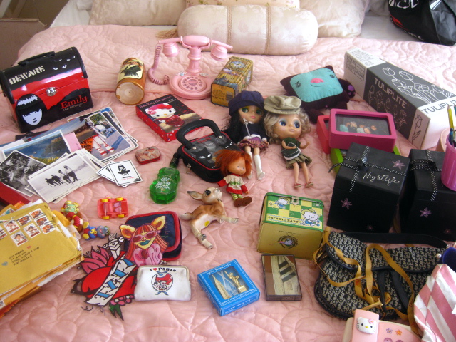 a very big pile of doll accessories all over the bed