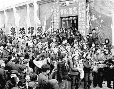 a group of men and women stand in front of an asian building while a crowd looks on