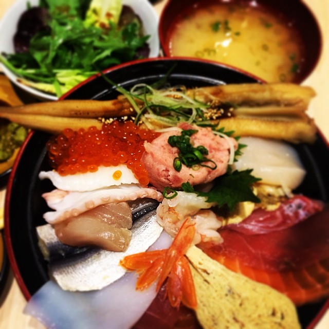 an elaborate japanese food meal is on a tray