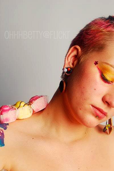 woman wearing yellow and pink makeup and ear rings