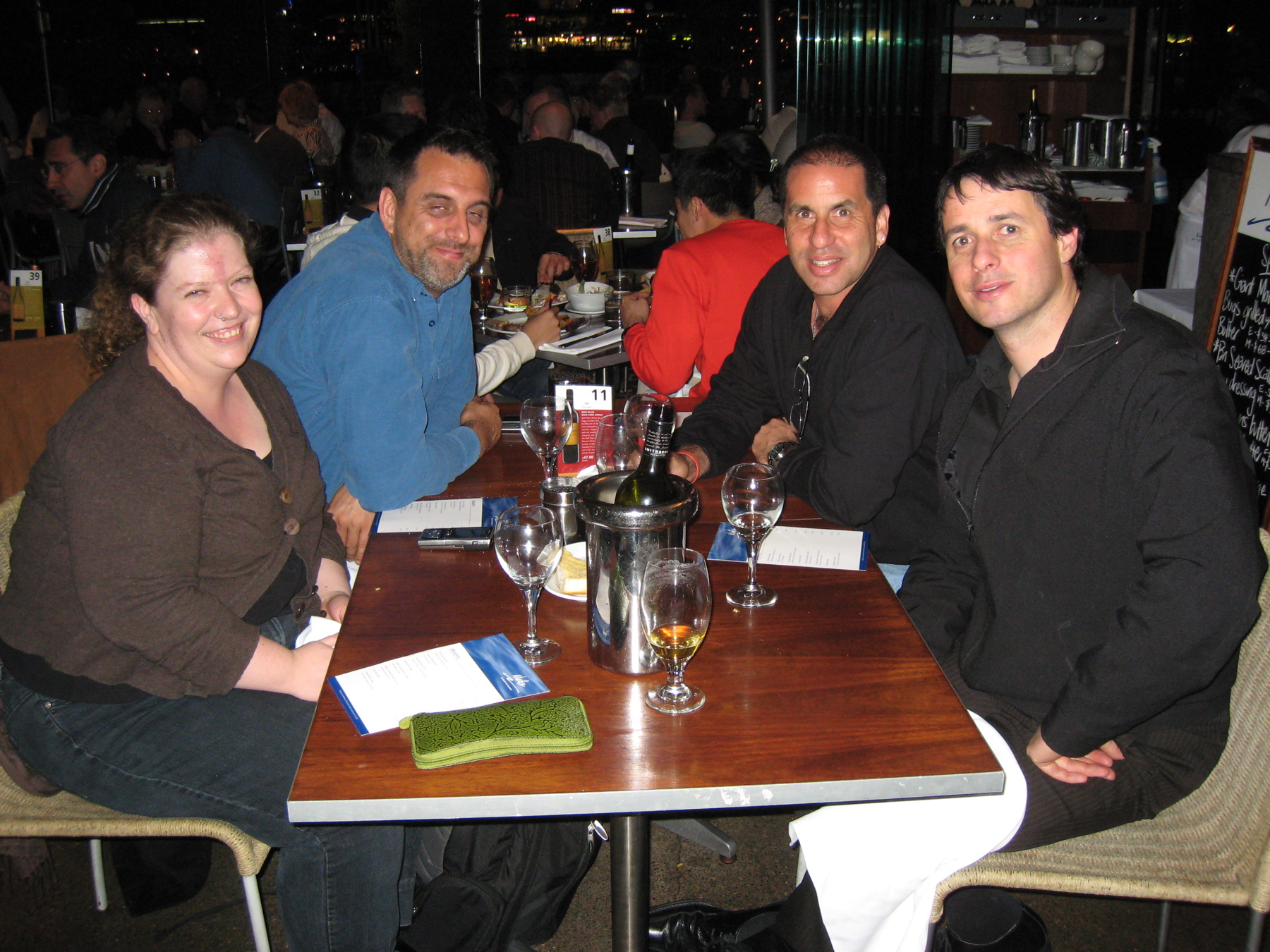 people sitting at a restaurant table with beverages in front of them