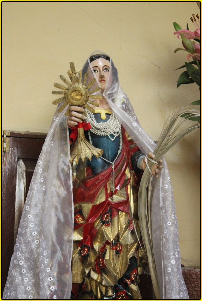 the statue of an immaculate woman holding up the sun in her hand