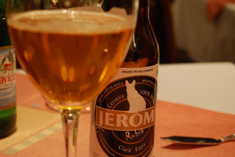 a glass of beer on a table next to a bottle of beer