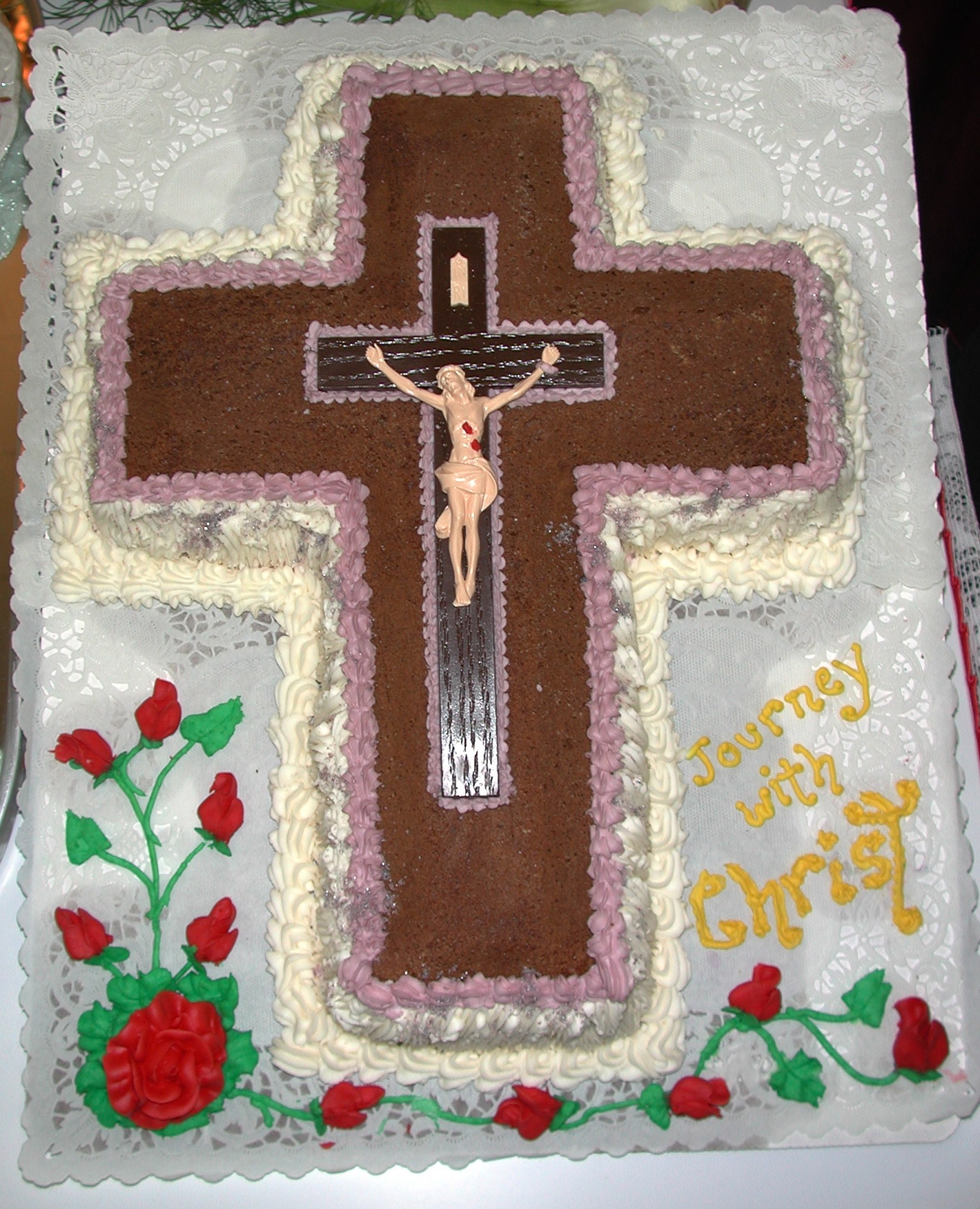 a decorated cake that has a crucifix on it