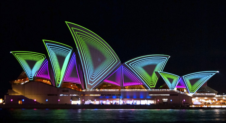 the opera opera on sydney's waterfront with bright lights in the sky