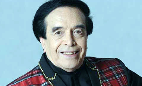 a man wearing a red and black checkered jacket