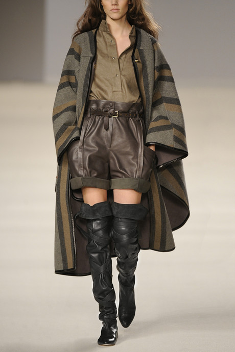 woman on runway with black boots and fur